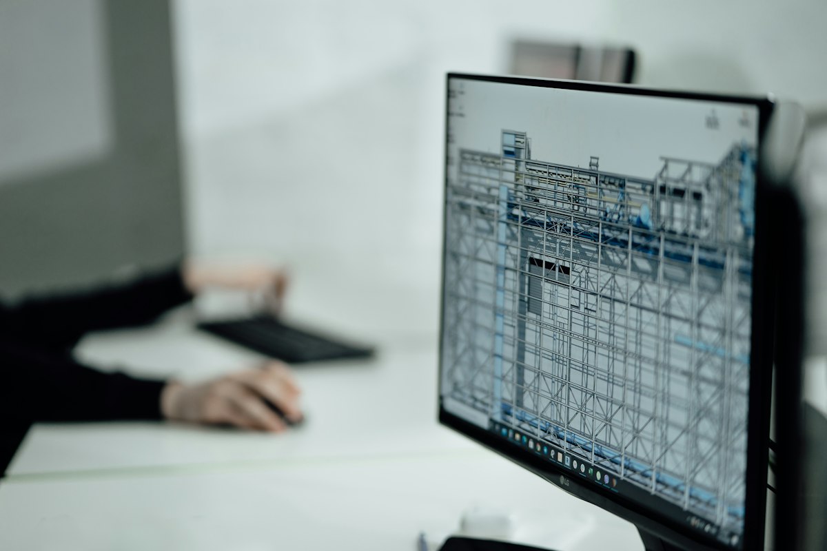 Architect producing a 2D CAD floor plan, the kind of drawing AutoCAD LT features handle as well as full AutoCAD