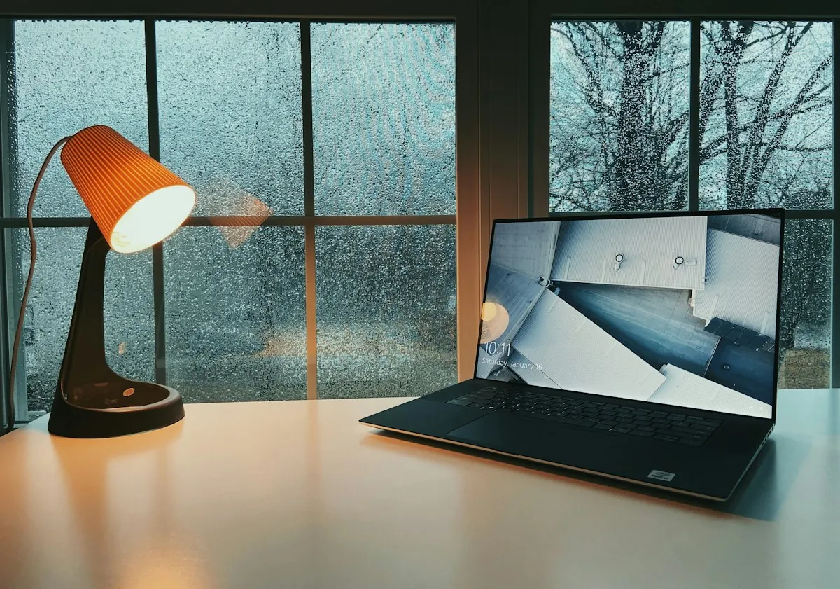 Windows laptop on a home office desk, used to compare Windows 11 Home vs Pro features